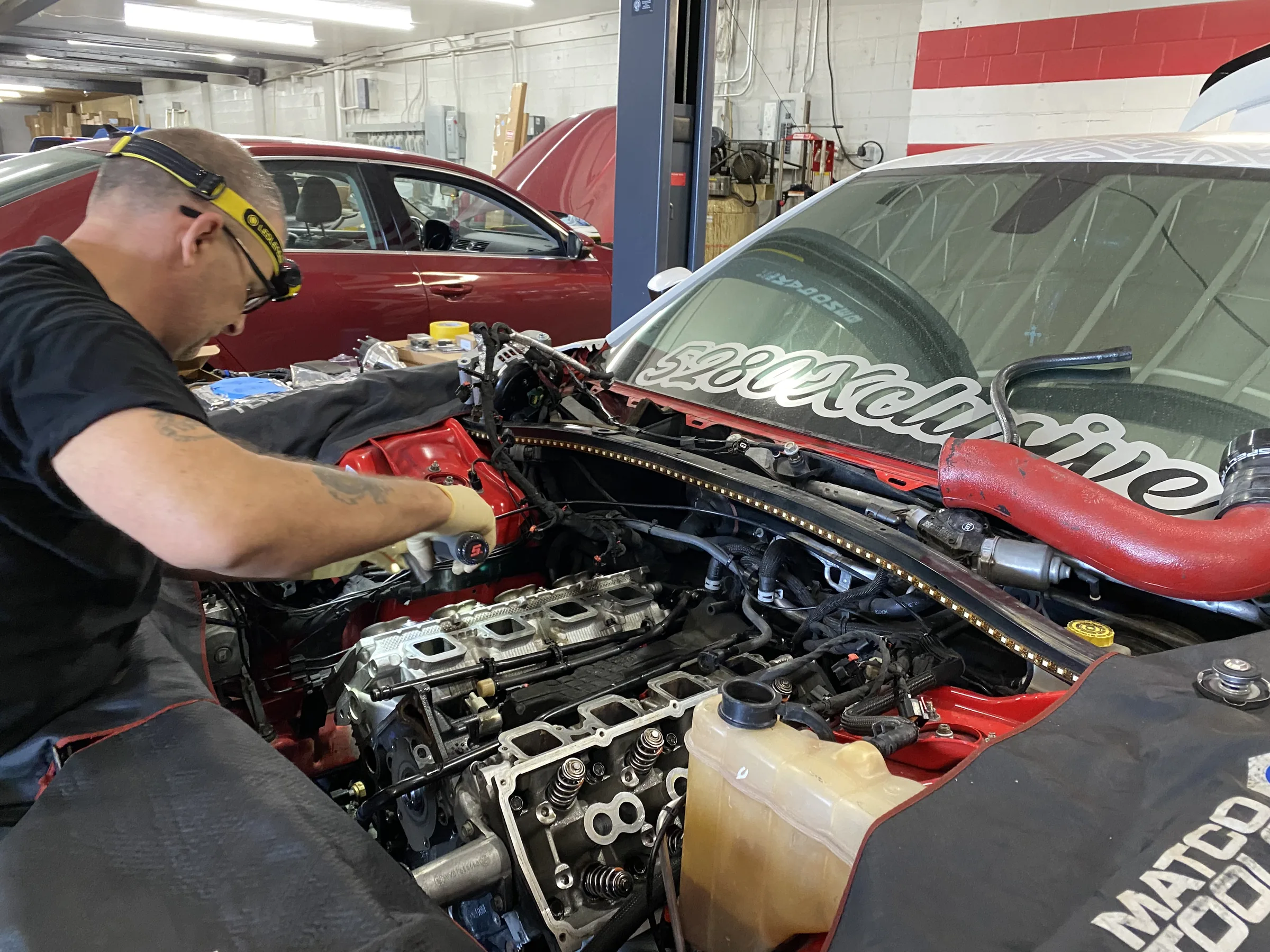 Engine upgrade with technician in shop
