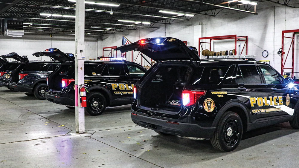 Fleet of police vehicles in shop