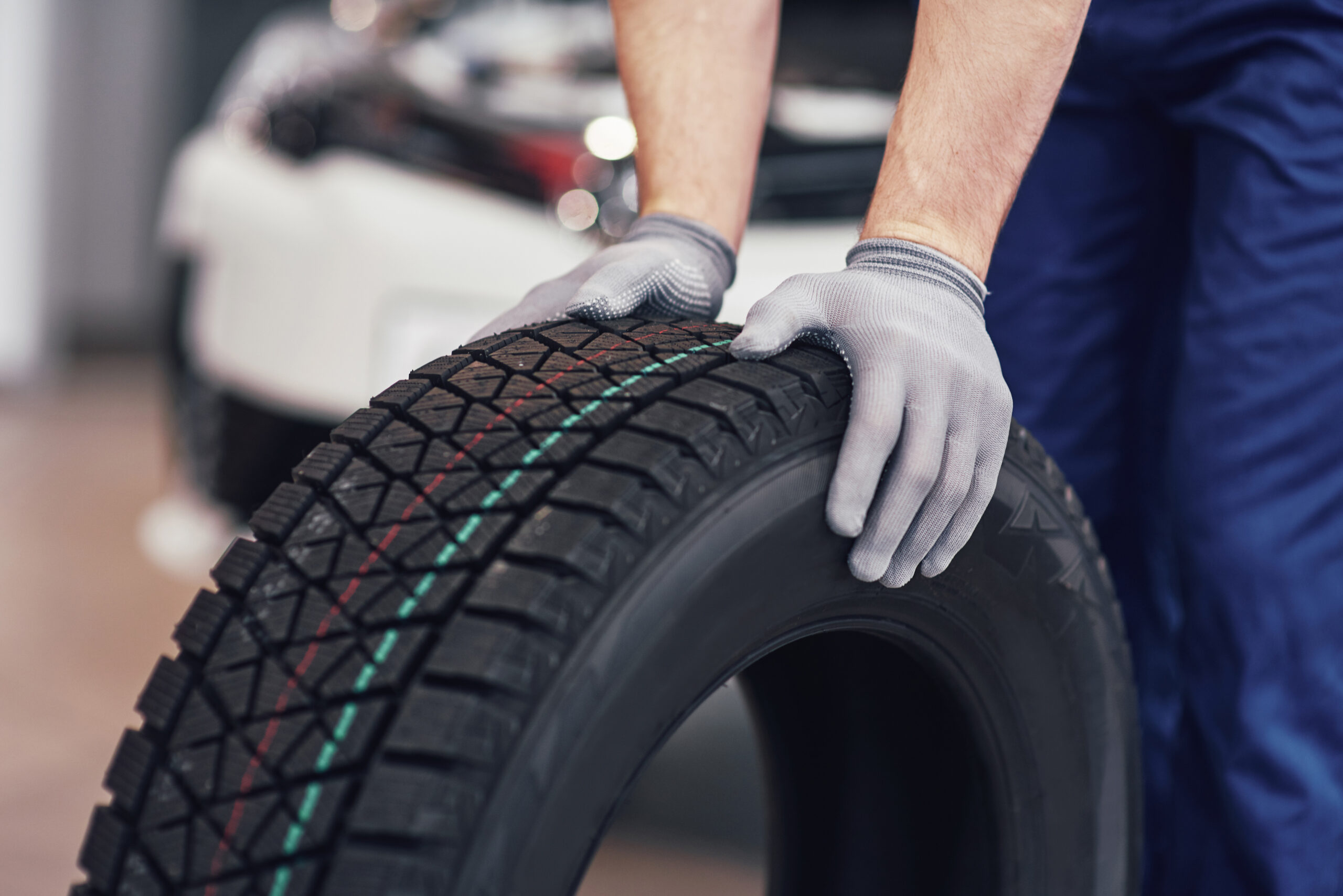 Technician handling a tire in the shop